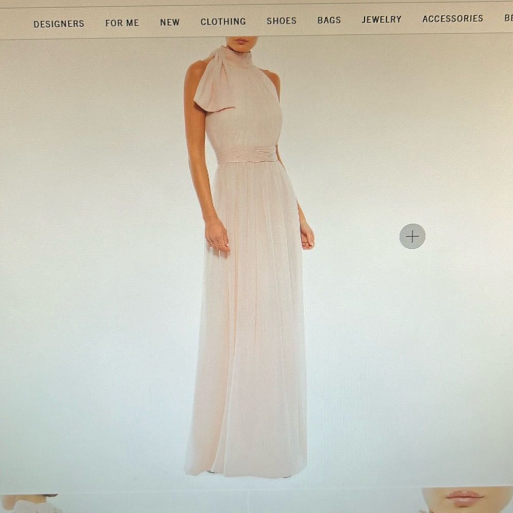 Mac Duggal’s sleeveless chiffon gown features a bow detailed high neck.